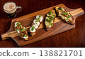 Delicious Bruschetta and a Coffee Drink on a Wooden Board 138821701