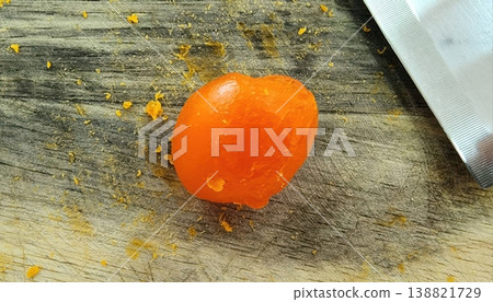 Close-up of Salted Duck Egg Yolk on Wooden Cutting Board with Knife 138821729