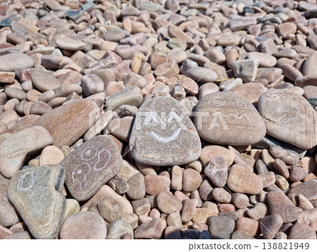 Various facial expressions drawn on pebbles Various facial expressions drawn on pebbles 138821949