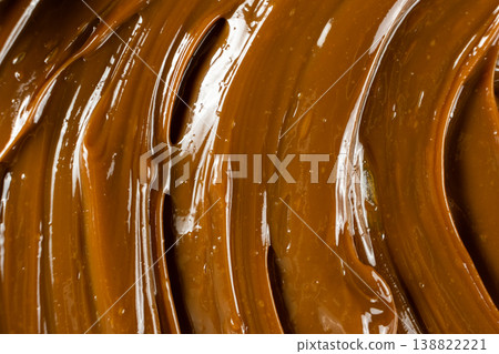 Thick caramel sauce swirl with glossy finish macro. 138822221