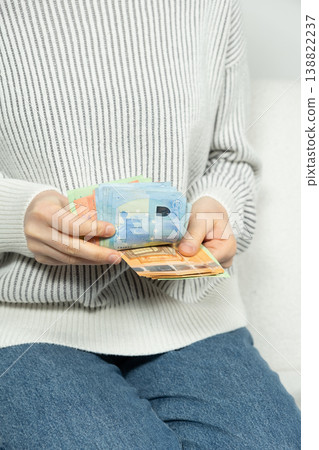 Hands holding and counting Euros. European Union currency. Hands holding and counting Euros. European Union currency. 138822237