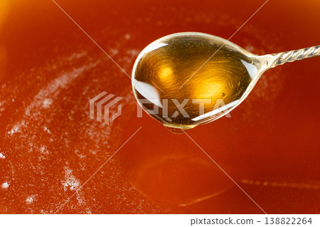 Spoon filled with golden maple syrup Spoon filled with golden maple syrup 138822264