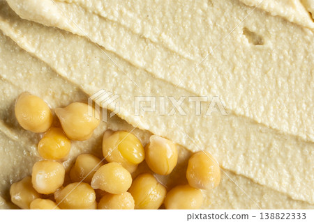 Boiled chickpeas on top of hummus texture macro Boiled chickpeas on top of hummus texture macro 138822333