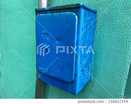 A metal mailbox for letters attached to a wall in the city limits A metal mailbox for letters attached to a wall in the city limits 138822354