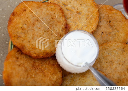 Crispy Potato Pancakes with Cream Topping Crispy Potato Pancakes with Cream Topping 138822364