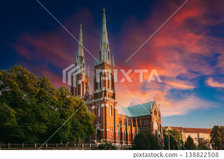 spectacular St. John's Church Johanneksenkirkko , a stunning gothic revival red brick building with tall twin spires, against an incredibly dramatic sunset sky in Helsinki 138822508