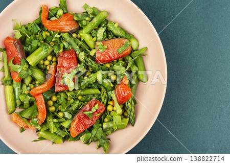 Green salad with smoked trout, peas and herbs. 138822714