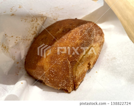 Malasada - A fried donut coated in sugar - Front view Malasada - A fried donut coated in sugar - Front view 138822724
