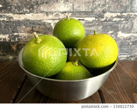 Kabosu - Domestically grown aromatic citrus fruit served in a silver bowl 138822730