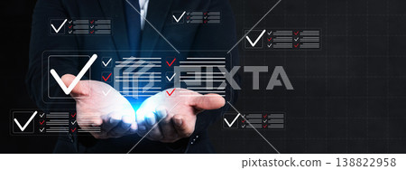 A businessman in a suit holds glowing holographic checklists, representing quality control, satisfaction surveys, compliance audits, and digital process management in a modern corporate setting 138822958