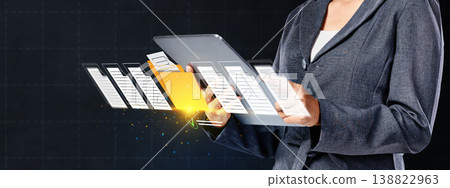 A corporate professional manages electronic files and folders floating from a tablet, illustrating cloud storage, digital transformation, and efficient paperless office solutions A corporate professional manages electronic files and folders floating from a tablet, illustrating cloud storage, digital transformation, and efficient paperless office solutions 138822963