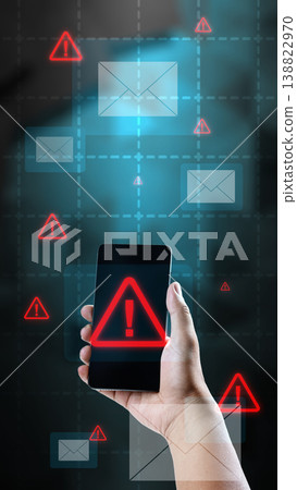A person holding a smartphone showing a red warning triangle alert, surrounded by floating email icons and warning signs, representing phishing, cyber threats, and mobile security risks A person holding a smartphone showing a red warning triangle alert, surrounded by floating email icons and warning signs, representing phishing, cyber threats, and mobile security risks 138822970