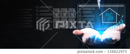A businessman holds a digital interface displaying house icons, percentage symbols, and growth charts, representing mortgage interest rates and real estate investment data analysis A businessman holds a digital interface displaying house icons, percentage symbols, and growth charts, representing mortgage interest rates and real estate investment data analysis 138822973