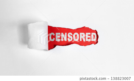 The word CENSORED is revealed on a red background through a rip in a plain white sheet of paper, symbolizing hidden information, media restriction, and secrets The word CENSORED is revealed on a red background through a rip in a plain white sheet of paper, symbolizing hidden information, media restriction, and secrets 138823007