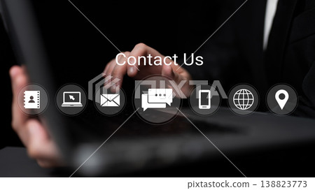 Hands Typing on Laptop Keyboard with Contact Us Icons Displayed on Screen in Professional Setting for Business Communication Gantry 138823773
