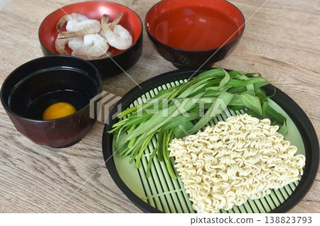 instant noodles with frozen shrimp and morning glory couple raw egg in water on bowl instant noodles with frozen shrimp and morning glory couple raw egg in water on bowl 138823793