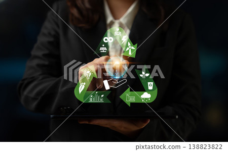 Business Professional Touching Digital Recycling Icon with Energy, Water, and Environment Symbols in a Dark Setting Quark 138823822