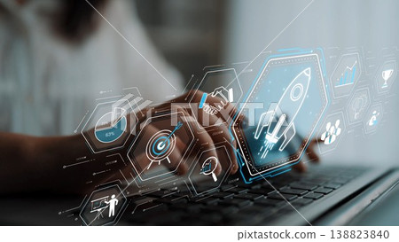 A close-up of a business professional working on a laptop. The digital interface displays icons representing innovative strategies for startups and business growth. Sigmoid A close-up of a business professional working on a laptop. The digital interface displays icons representing innovative strategies for startups and business growth. Sigmoid 138823840