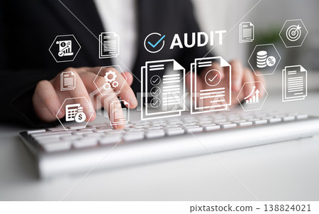 Hands Typing on Keyboard with Audit Symbols and Graphics Representing Data Analysis, Financial Reporting, and Business Review Concepts Ledger Hands Typing on Keyboard with Audit Symbols and Graphics Representing Data Analysis, Financial Reporting, and Business Review Concepts Ledger 138824021