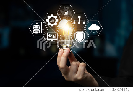 Hand Holding Light Bulb with Technology Icons Representing Innovation, Data Management, Cloud Computing, and Artificial Intelligence Concepts Quark Hand Holding Light Bulb with Technology Icons Representing Innovation, Data Management, Cloud Computing, and Artificial Intelligence Concepts Quark 138824142