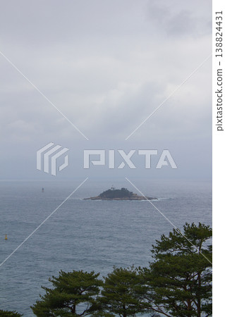 It is a quiet seascape with a small island. 138824431
