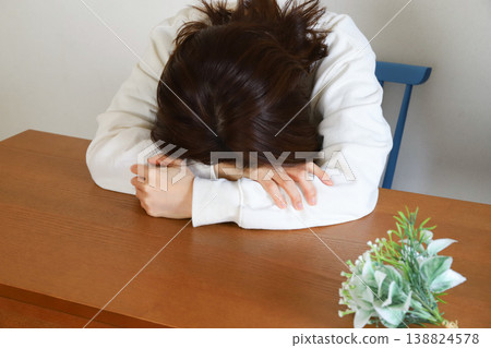 A woman looking down and feeling depressed A woman looking down and feeling depressed 138824578