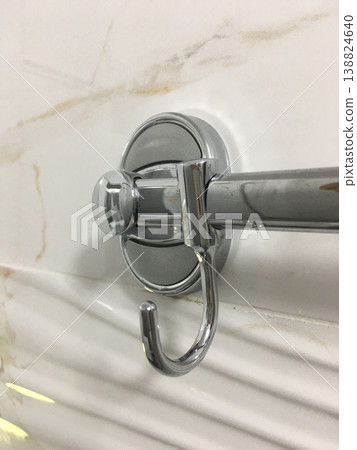 Close-up of a chrome towel holder on a marble bathroom wall showing a functional design in a modern setting Close-up of a chrome towel holder on a marble bathroom wall showing a functional design in a modern setting 138824640