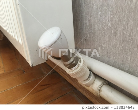 Heating valve and pipes located near a wall in a room during winter season Heating valve and pipes located near a wall in a room during winter season 138824642