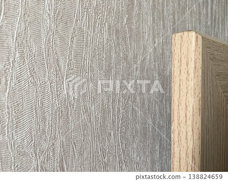 Wood meets textured wall in indoor space showing design and material contrast Wood meets textured wall in indoor space showing design and material contrast 138824659