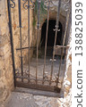 Antique Wrought Iron Gate Guarding Entrance to Ancient Stone Tunnel 138825039