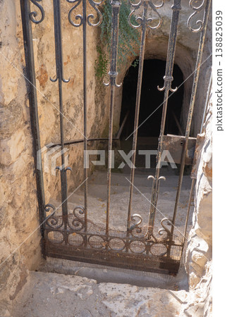Antique Wrought Iron Gate Guarding Entrance to Ancient Stone Tunnel Antique Wrought Iron Gate Guarding Entrance to Ancient Stone Tunnel 138825039