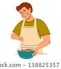 Contented man in an apron add seasonings onto a fresh salad. Cooking scene featuring healthy food 138825357