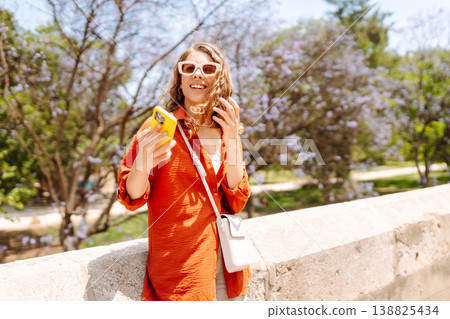Young woman using smart phone and smile with walking in city outdoor. Business, blogging concept. 138825434