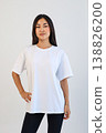 Ecommerce promotional image showcasing confident woman wearing white tshirt in studio setting 138826200