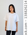 Ecommerce promotional image showcasing confident woman wearing white tshirt in studio setting 138826214
