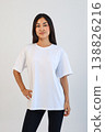 Ecommerce promotional image showcasing confident woman wearing white tshirt in studio setting 138826216