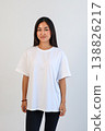 Ecommerce promotional image showcasing confident woman wearing white tshirt in studio setting 138826217