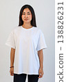 Ecommerce promotional image showcasing confident woman wearing white tshirt in studio setting 138826231