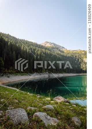 Incredible view in mountains of the lake. Rocky shore of mountain lake in the morning. Incredible view in mountains of the lake. Rocky shore of mountain lake in the morning. 138826409
