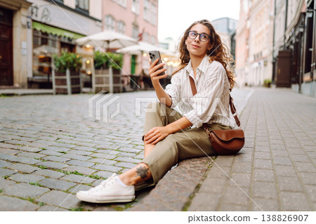 Young woman with phone on the street. Technology, blogging, communication concept. 138826907
