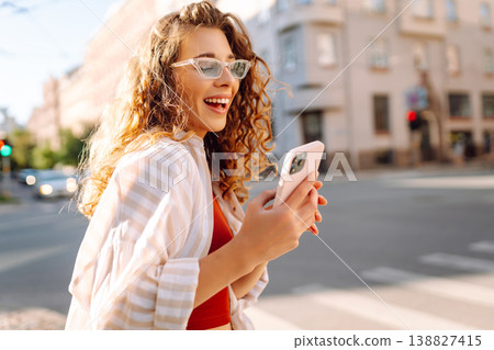 Happy woman tourist with phone. Young woman writing text for sharing content about vacations 138827415
