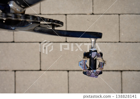 Close-up of a bicycle clipless pedal and crank arm 138828141