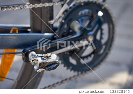 Close up of bicycle pedal on crank arm and chain on road bike 138828145