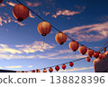 A landscape image featuring traditional Japanese lanterns gently glowing against a beautiful blue twilight sky, creating a fantastical atmosphere. 138828396