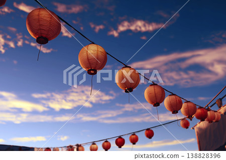 A landscape image featuring traditional Japanese lanterns gently glowing against a beautiful blue twilight sky, creating a fantastical atmosphere. 138828396