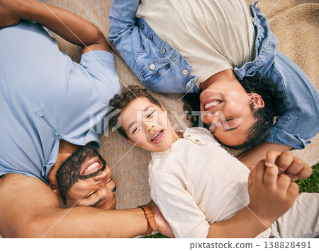 Happy family, above and relax at a park, bonding and enjoying the weekend outdoor. Top view, smile and boy child with parents on a field with freedom, love and vacation, care and chilling on lawn Happy family, above and relax at a park, bonding and enjoying the weekend outdoor. Top view, smile and boy child with parents on a field with freedom, love and vacation, care and chilling on lawn 138828491