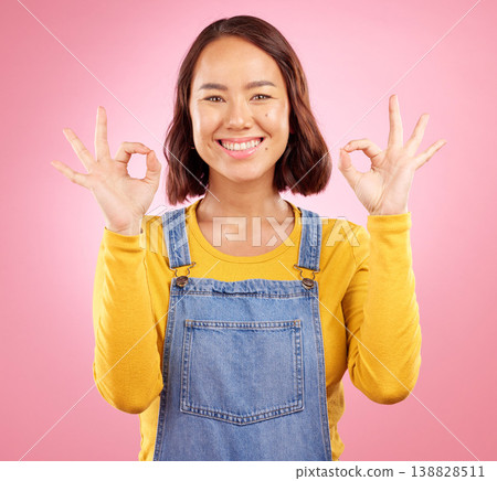 Smile, okay and yes with portrait of woman in studio for support, agreement and motivation. Winner, emoji and success with face of person on pink background for achievement, thank you and vote sign Smile, okay and yes with portrait of woman in studio for support, agreement and motivation. Winner, emoji and success with face of person on pink background for achievement, thank you and vote sign 138828511