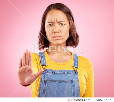 Woman, hand and stop in studio portrait with angry face, rejection or bad review by pink background. Gen z student girl, icon or emoji for protest, voice or opinion for feedback, activism or warning Woman, hand and stop in studio portrait with angry face, rejection or bad review by pink background. Gen z student girl, icon or emoji for protest, voice or opinion for feedback, activism or warning 138828526