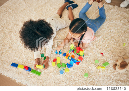 Relax, play and above of children on floor with building blocks for learning, education and child development. Family, home and top view of girls in living room with toys for fun, creativity or games Relax, play and above of children on floor with building blocks for learning, education and child development. Family, home and top view of girls in living room with toys for fun, creativity or games 138828540