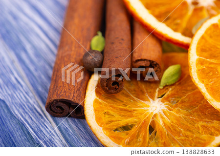 Dry orange slices with cinnamon sticks, allspice berries and cardamom seeds. 138828633